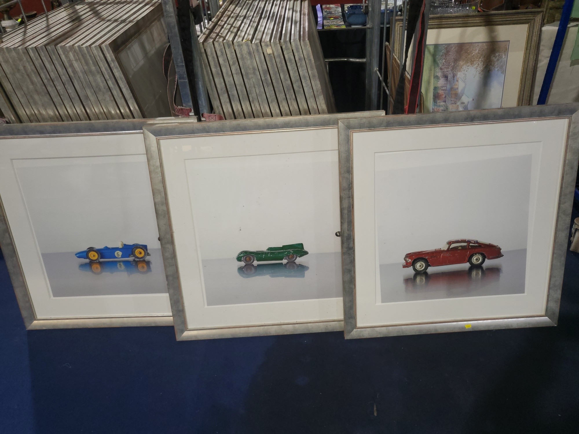 A Set of Fifteen Framed and Glazed photographs of Vintage Toy Cars, in ...