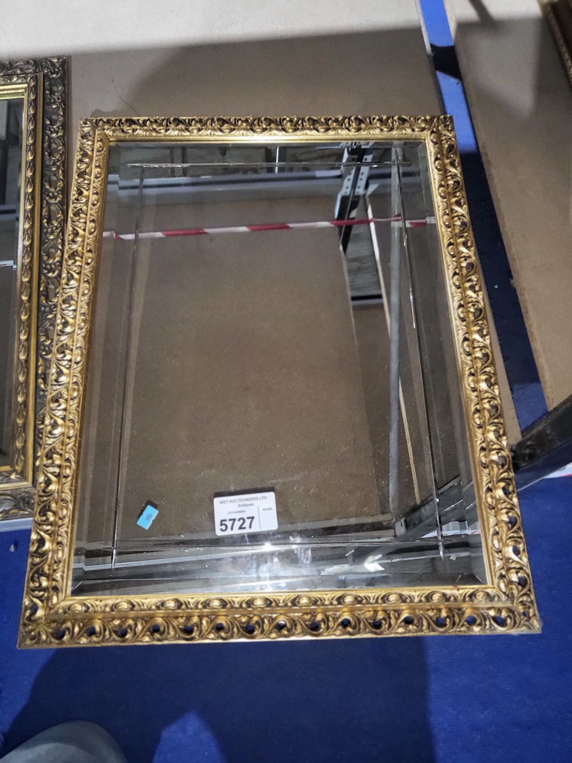 A gilt framed rectangular bevelled wall mirror, approximately 68cms X 51cms