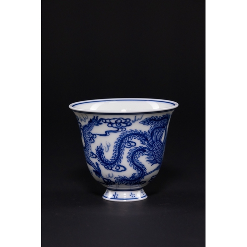 232 - A CHINESE BLUE AND WHITE PORCELAIN DRAGON AND PHOENIX CUP, DAOGUANG MARK. - The exterior is expertly... 