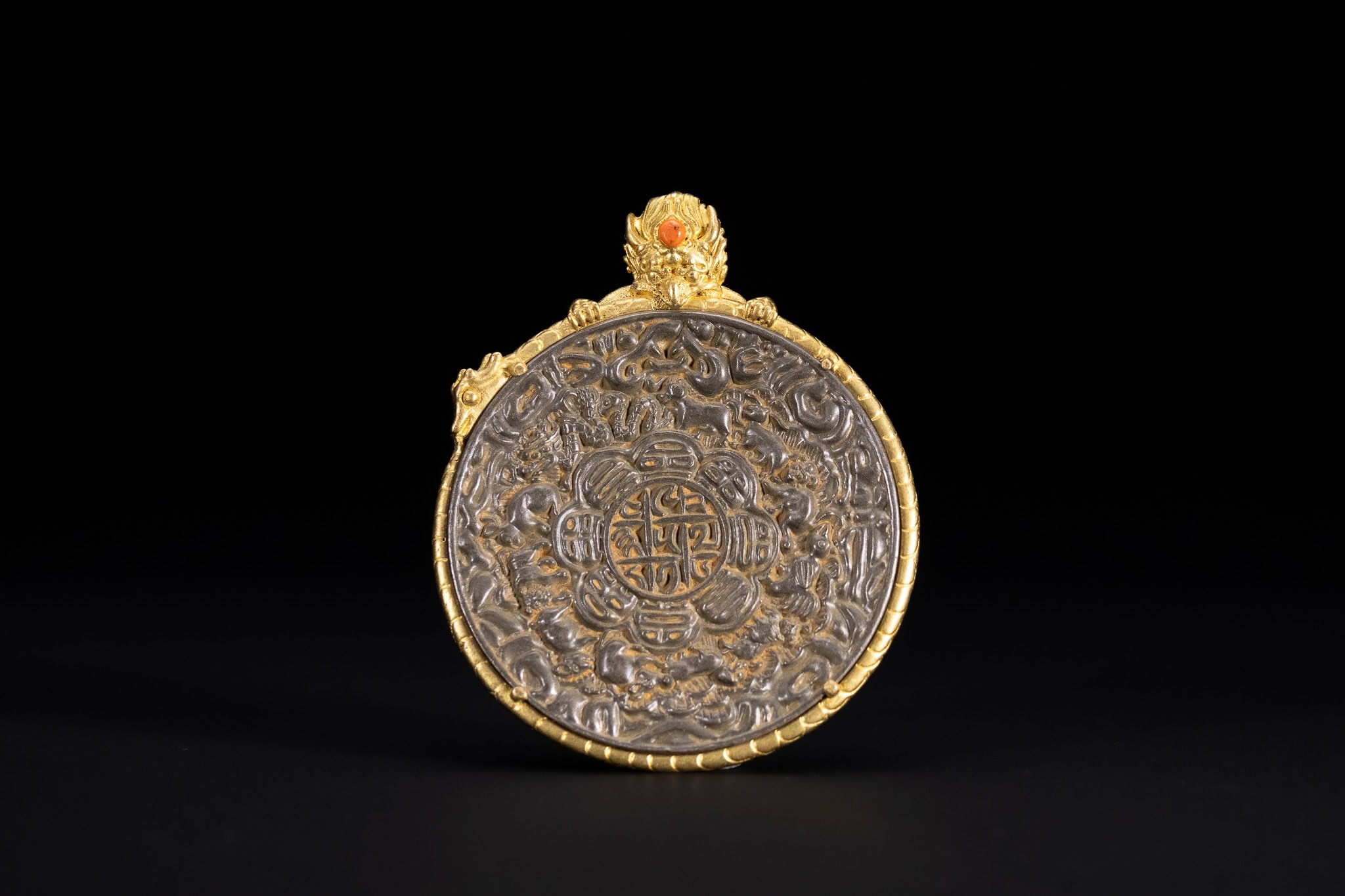A TIBETAN GILDED COPPER ALLOY AND IRON ASTROLOGICAL MELONG PENDANT ...