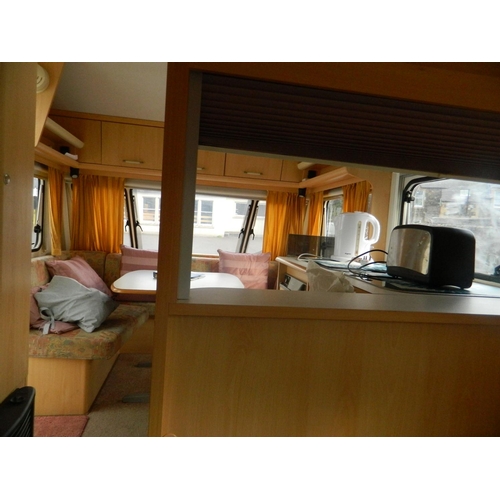 124 - Lunar 470 2003 4 berth caravan with awning, also includes inbuilt cooker, fridge, shower and toilet,... 