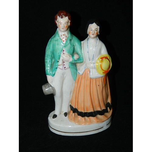 11 - Staffordshire pottery 'Courting Couple' standing in archway and Staffordshire flatback couple