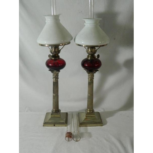 79 - Pair of EP column table lamps with ruby glass reservoir and milk glass shades, 52cm