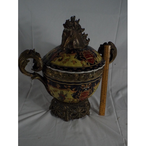 76 - Crested twin handled urn with horse head finial