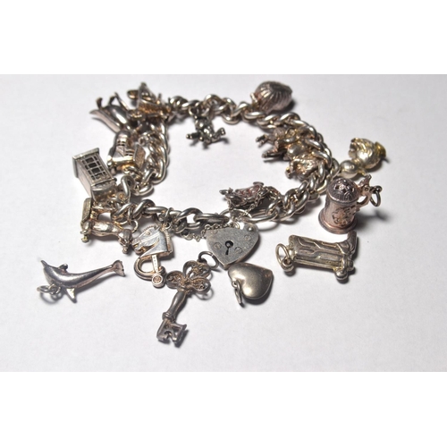 116 - Silver charm bracelet having 17 various charms include animals, heart, key etc (some loose)