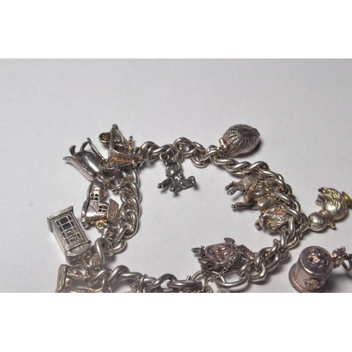 116 - Silver charm bracelet having 17 various charms include animals, heart, key etc (some loose)