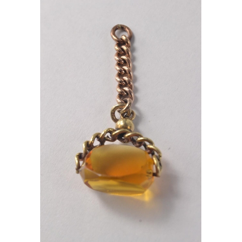 116E - Yellow metal watch fob with amber coloured stone