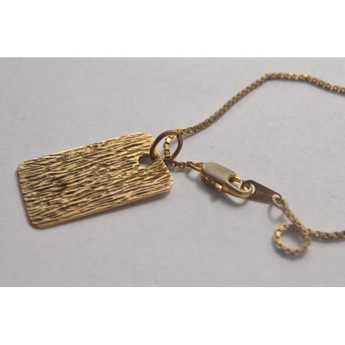 142C - 375 Gold ingot with a yellow metal small charm suspended from a 18k plated 22in chain 9.26 grm gross... 