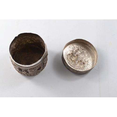 169G - Unusual Oriental silver circular lidded box with traditional intricate decoration to the base and li... 