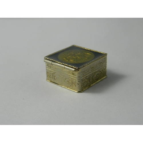 173D - Full 1913 Gold Sovereign set in a square [1 x1 inch] white metal pill box with scroll work design. a... 