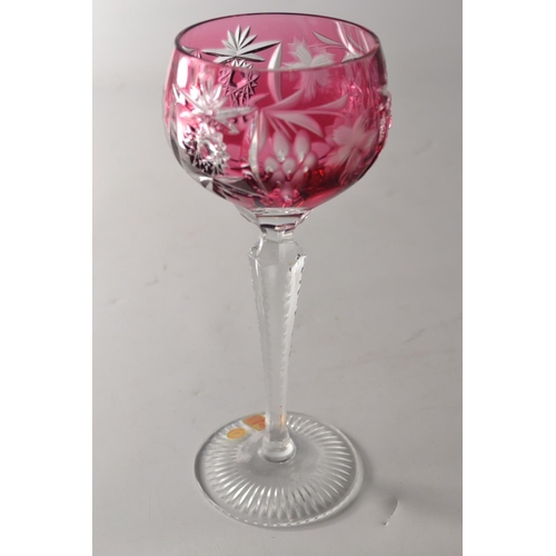 219 - Four Nachtman 24% lead crystal 'Grape' wine hock glasses in various colours to include blue, amber, ... 