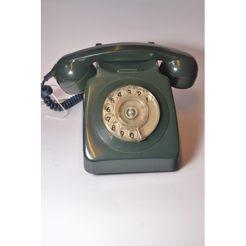 25 - 1970's Green plastic telephone, with circular finger turning dial. [12cm high] Working, Marks expect... 