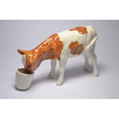 29 - SHEBEG pottery model of a farmer and his dog, together with a model of a Ayrshire calf.[2] {H: 11and... 