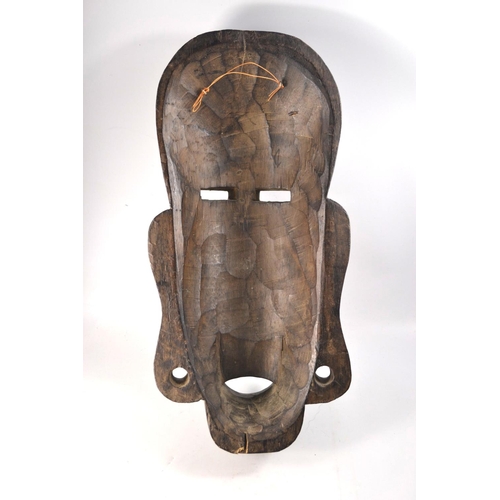 58B - Ebonised carved African face mask 46cm tall.