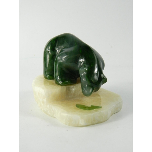 77 - Canadian Jade Polar Bear model, the carved model hunting a fish on polished stone base, Q9216, etche... 