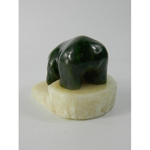 77 - Canadian Jade Polar Bear model, the carved model hunting a fish on polished stone base, Q9216, etche... 