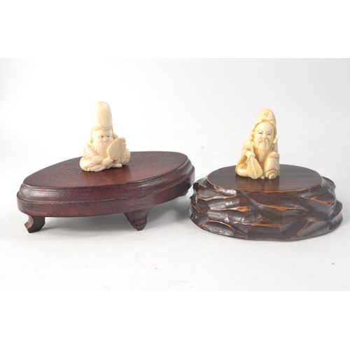 79 - 2 Chinese carved bone Netsukes in the form of Shou Lao with 2 wooden bases