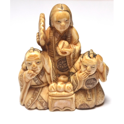 82 - Chinese carved bone netsuke in the form of three figures in a group