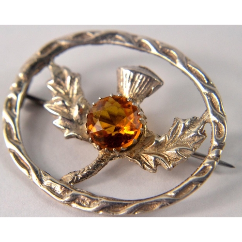 27 - Ladies Scottish silver Thistle design dress brooch with amber coloured stone