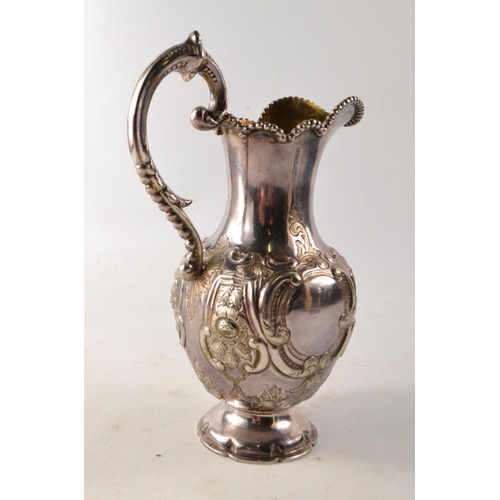 137 - 19th C Glasgow silver ewer, with scrolling and floral decoration, gilt lined interior