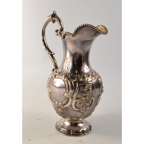 137 - 19th C Glasgow silver ewer, with scrolling and floral decoration, gilt lined interior