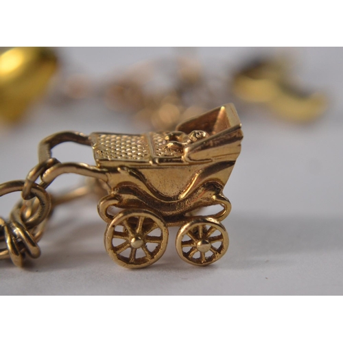 27 - 9 Carat gold charm bracelet to include 6 charms and a mounted quarter Kruggerand (POND)