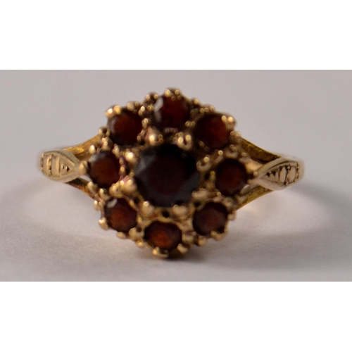 31 - A 9ct gold floral garnet cluster set ring, with 9 garnets size O