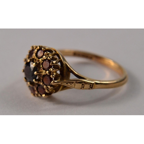 31 - A 9ct gold floral garnet cluster set ring, with 9 garnets size O