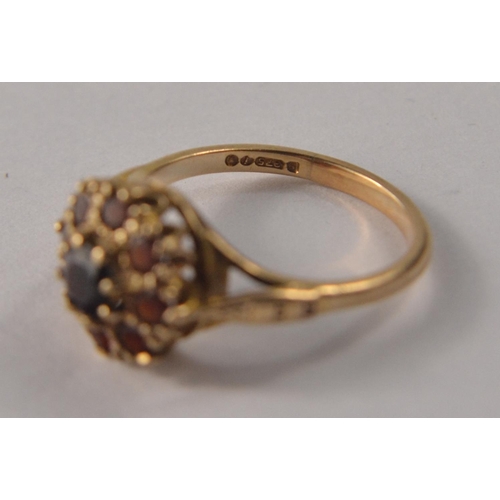 31 - A 9ct gold floral garnet cluster set ring, with 9 garnets size O