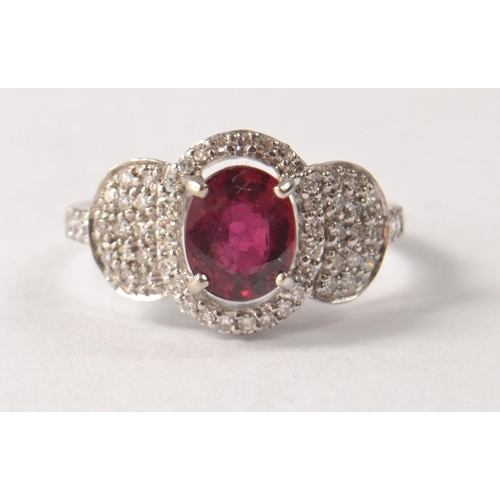 43 - 18 carat Birmingham white gold ruby and diamond ring. Size O. Set with oval ruby (L 8mm x W 5mm), en... 