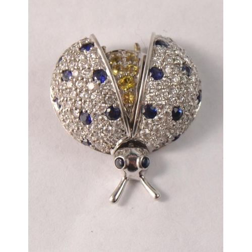 56 - Stunning 18ct white gold lady bird pin set with white diamond, yellow diamond and saphires. Body dep... 