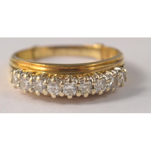 63 - 18ct gold 9 diamond set ring in a raised setting. With 9ct sizer insert (Size T/U)