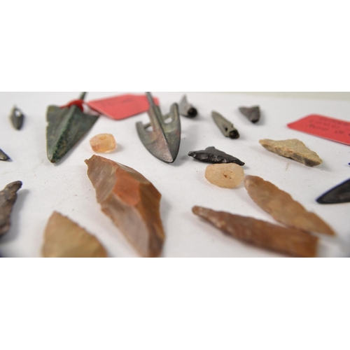 78 - Selection of metal and stone arrowheads, possibly African. Some with information tags of Greek origi... 