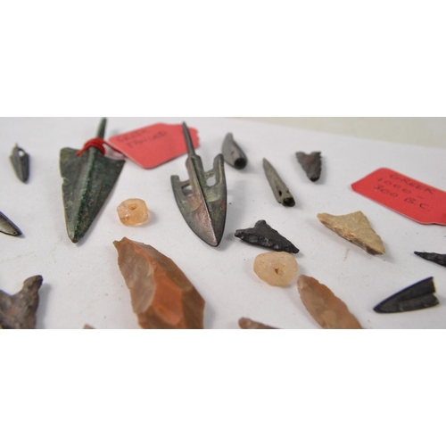 78 - Selection of metal and stone arrowheads, possibly African. Some with information tags of Greek origi... 