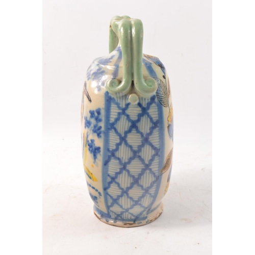 191 - Faience twin handled vase, hand painted with birds.