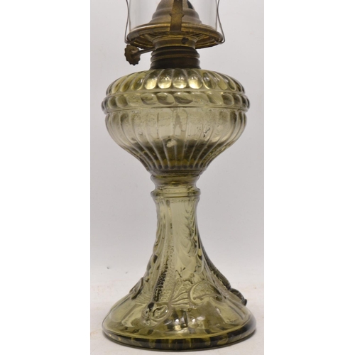 203 - Small oil lamp H 47cm approx, pressed decorative glass with an unusual glass font shade top, 47cm fr... 