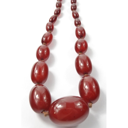 35 - STUNNING! A Vintage string of reddish graduated beads