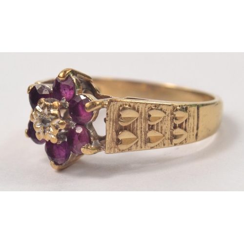 61 - 9ct Amethyst and diamond floral set ring, with hearts on the shoulders. Size M