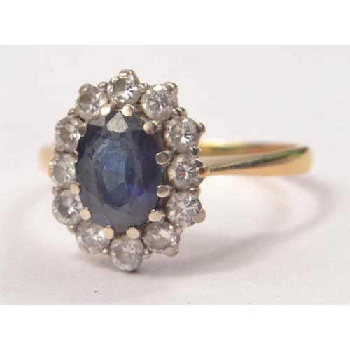 67 - 18ct Hallmarked yellow and white gold mounted saphire and diamond cluster ring with a total sapphire... 