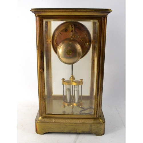 82 - A c1900's French large brass 4 sided glass clock with enameled numeral face. With mercury filled pen... 