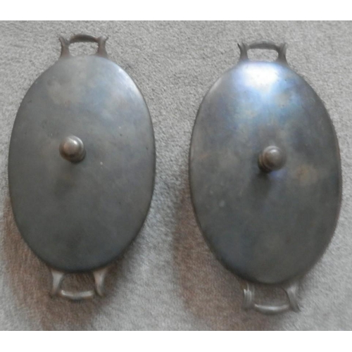 170 - Two W.A.S.Benson enamelled copper oval serving dishes with covers. The heavy cast base has a white e... 