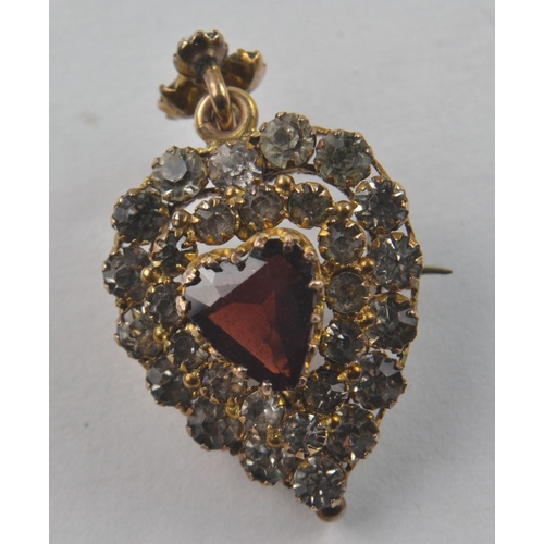 162 - Early Victorian 9ct heart shaped pendant/brooch. Red heart shaped stone surrounded by clear paste st... 