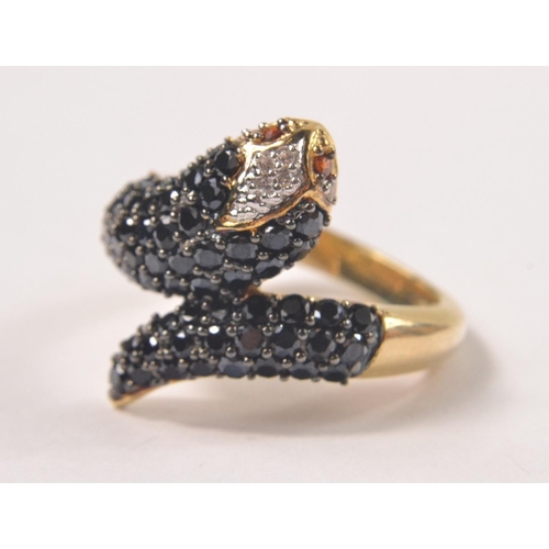 34 - Gilded 925 stamped ring in the design of a snakes head and tail, set with black and clear stones wit... 