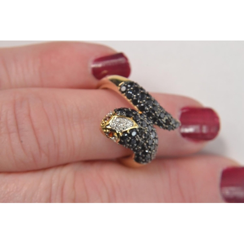 34 - Gilded 925 stamped ring in the design of a snakes head and tail, set with black and clear stones wit... 