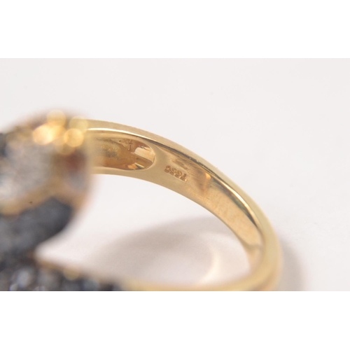 34 - Gilded 925 stamped ring in the design of a snakes head and tail, set with black and clear stones wit... 