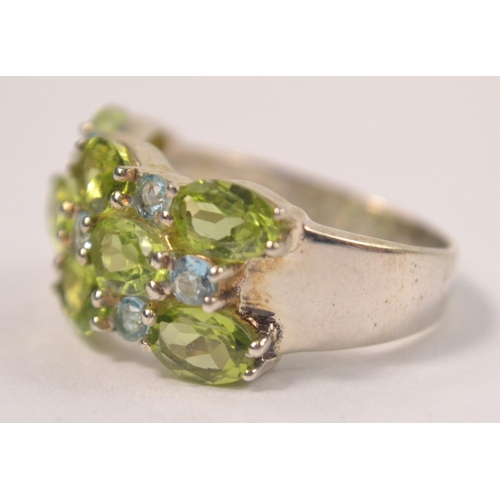 41 - 925 Silver stamped ring, set with 8 pale green stones with 7 very pale blue stone spacers Size P