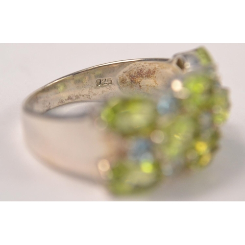 41 - 925 Silver stamped ring, set with 8 pale green stones with 7 very pale blue stone spacers Size P