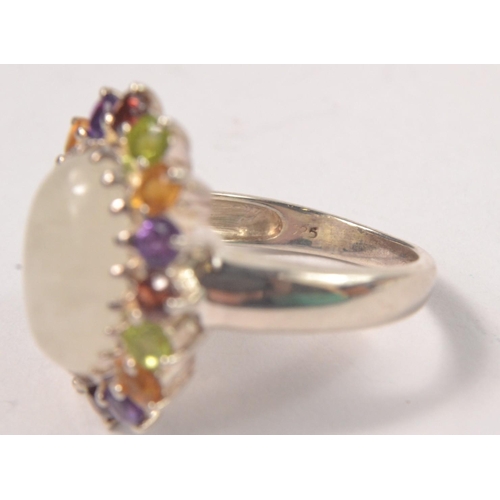 44 - 925 Silver stamped oval ring, set with central stone flanked by 16 multi coloured stones in a petal ... 