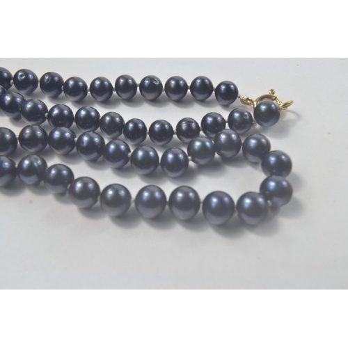 94 - String of Purple pearls with 9ct fastening [L: 42cm]