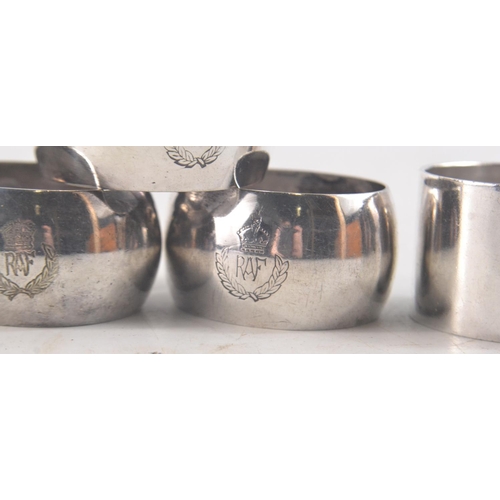 127 - Selection of 11 white metal napkin rings. 3 embossed RAF, 7 embossed  